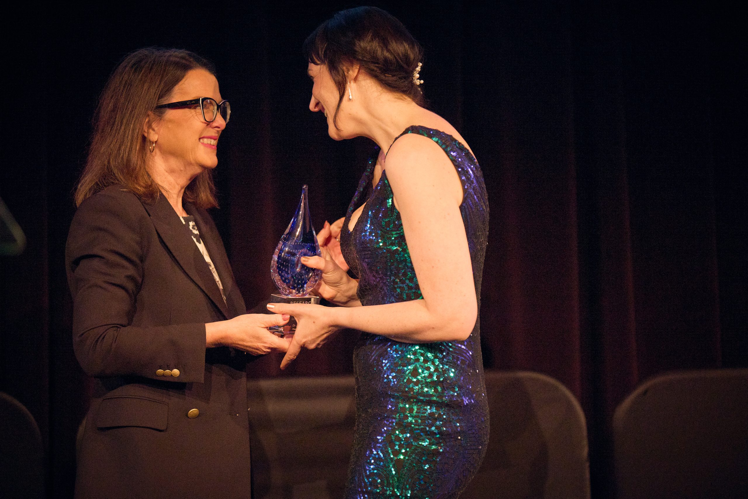 Dr Jane Tiller receiving the Research Australia AbbVie Advocacy Award on stage